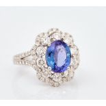 An 18ct white gold, tanzanite and diamond set cluster ring