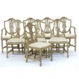 A set of eight distressed grey painted Hepplewhite style shield back dining chairs