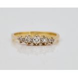 A gold and diamond set five stone ring