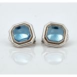 A pair of cabochon blue topaz and white gold earclips