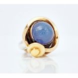 A gold, silver and tanzanite set dress ring by Tom McEwan