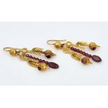 A pair of gold and red gem set drop shaped pendant earrings