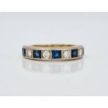 A gold, diamond and sapphire set half hoop eternity ring