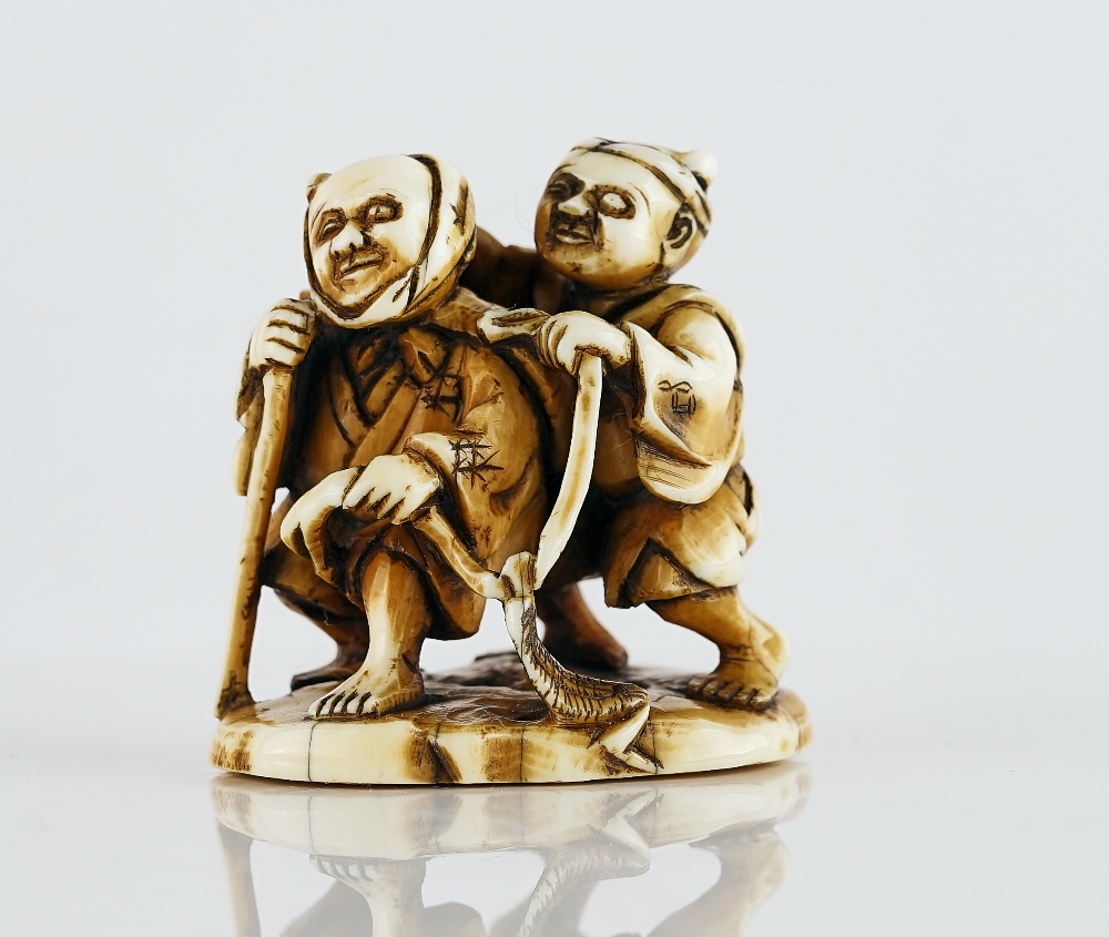 A Japanese ivory netsuke of two blind men