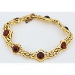 A gold and carbuncle garnet bracelet