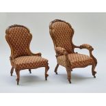 A pair of Victorian mahogany framed lady's and gentleman's easy chairs