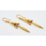 A pair of gold pendant earrings