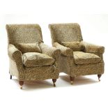 A pair of easy armchairs