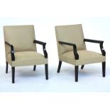 A pair of ebonised square back open armchairs