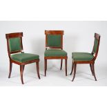 A set of eight Empire style mahogany and brass dining chairs on sabre legs