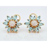 A pair of gold, blue topaz and diamond set earstuds