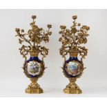 A pair of French gilt-metal and porcelain five light candelabra