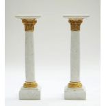A pair of gilt-metal mounted white marble columns