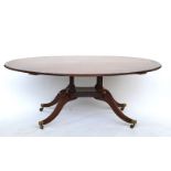 A George III style oval coromandel banded mahogany centre table