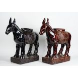 A pair of brown glazed pottery jardinieres modelled as donkeys