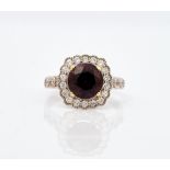 An 18ct white gold, purple spinel and diamond cluster ring