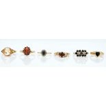 A 9ct gold and garnet set oval cluster ring and five further 9ct gold rings (6)