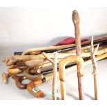 A group of 20th century wooden walking sticks and two umbrellas. (Qty)