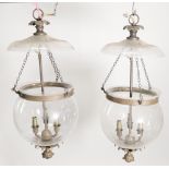 A pair of modern metal and glass hanging hundi lanterns