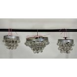 A group of three modern metal and glass drop decorated ceiling lights (3)