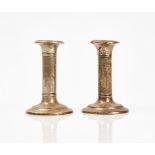 A pair of silver mounted candlesticks and a silver and tortoiseshell mounted glass smelling...