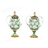 A pair of Minton white and celadon ground two-handled vases and covers
