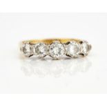 A GOLD AND DIAMOND FIVE STONE RING