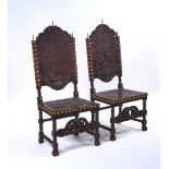 A PAIR OF 17TH CENTURY STYLE SPANISH STUDDED AND EMBOSSED LEATHER HIGHBACK SIDE CHAIRS