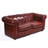 A 20TH CENTURY BROWN LEATHER UPHOLSTERED CHESTERFIELD SOFA
