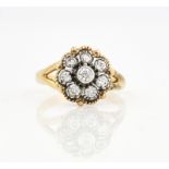 A GOLD AND DIAMOND EIGHT STONE CLUSTER RING