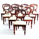 A SET OF TEN VICTORIAN WALNUT BALLOON BACK DINING CHAIRS