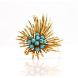 A GOLD AND TURQUOISE BROOCH