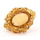 A VICTORIAN TWO COLOUR GOLD AND CITRINE SINGLE STONE BROOCH