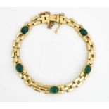 A GOLD AND CABOCHON EMERALD BRACELET