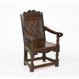 A CHARLES I JOINED OAK PANEL-BACK OPEN ARMCHAIR