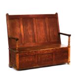 A 19TH CENTURY PITCH PINE BOX SEAT SETTLE