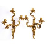 A PAIR OF LOUIS XV STYLE ORMOLU THREE BRANCH WALL LIGHTS