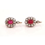 A PAIR OF DIAMOND AND SYNTHETIC RED SPINEL OVAL CLUSTER EARRINGS