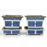 A PAIR OF CHINESE BLUE AND WHITE JARDINIERES AND STANDS