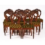 A SET OF TWELVE VICTORIAN CARVED MAHOGANY DINING CHAIRS