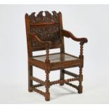 A CHARLES II JOINED OAK OPEN ARMCHAIR