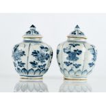 A PAIR OF SMALL CHINESE BLUE AND WHITE VASES AND COVERS