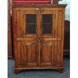 AN INDIAN TEAK TWO DOOR FOOD CUPBOARD