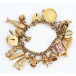 A 9CT GOLD CURB LINK CHARM BRACELET