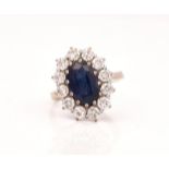 A 18CT WHITE GOLD, SAPPHIRE AND DIAMOND SET OVAL CLUSTER RING