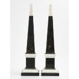 A PAIR OF BLACK FOSSIL MARBLE AND WHITE MARBLE MOUNTED OBELISKS