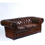 A 20TH CENTURY STUDDED BROWN LEATHER UPHOLSTERED CHESTERFIELD SOFA