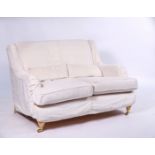 A MODERN TWO SEATER SOFA