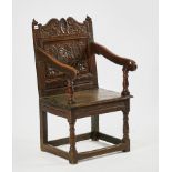 A CHARLES II JOINED OAK OPEN ARMCHAIR