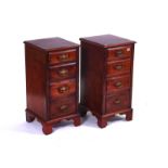 A PAIR OF WALNUT FOUR DRAWER BEDSIDE CHESTS